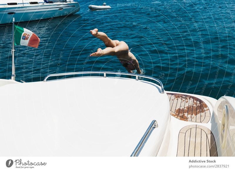 Woman jumping from yacht Yacht Jump Swimming Transport Athletic amusement Freedom Sailboat Ocean romantic Swimmer (professional sportsman) Relaxation Summer