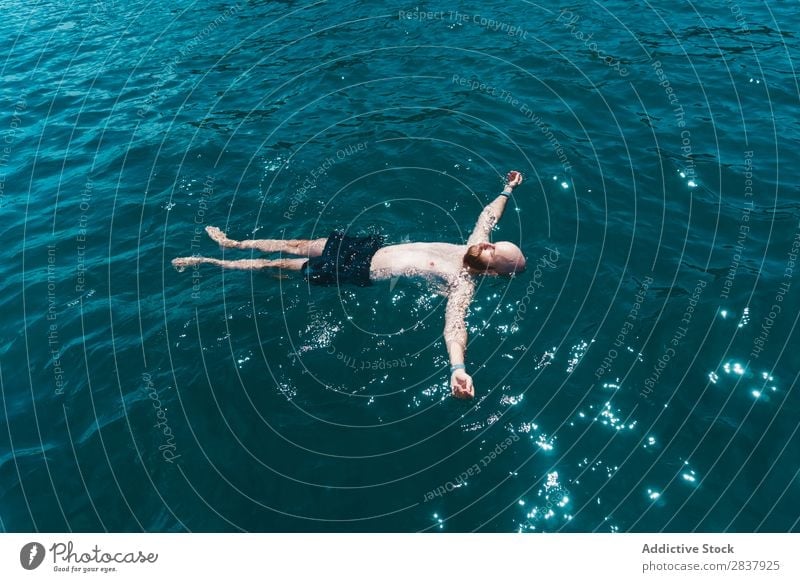 Man floating in blue water Ocean Water Floating Swimming Resort Relaxation Peace enjoyment Summer Vacation & Travel Leisure and hobbies on back
