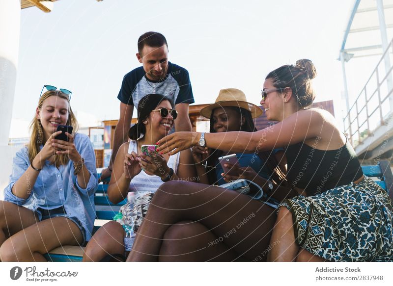 Friends with smart phones relaxing outside Human being Friendship Relaxation PDA Share Traveling Terrace Cheerful Technology Happiness Communication gathering