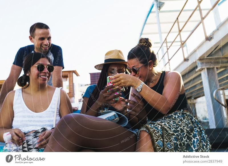 Friends with smart phones relaxing outside Human being Friendship Relaxation PDA Share Traveling Terrace Cheerful Technology Happiness Communication gathering