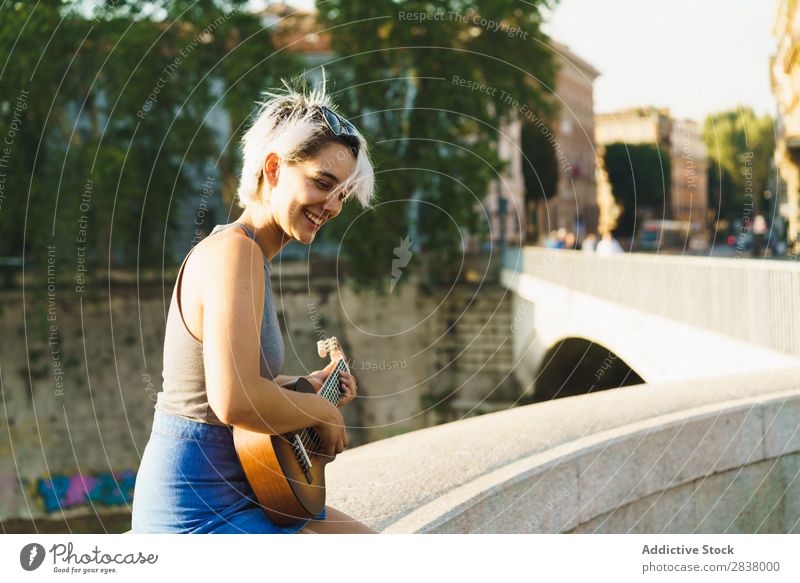 Girl playing small guitar at street Woman Street Entertainment Ukulele Musician City Lifestyle Style Summer Leisure and hobbies Beauty Photography Uniqueness
