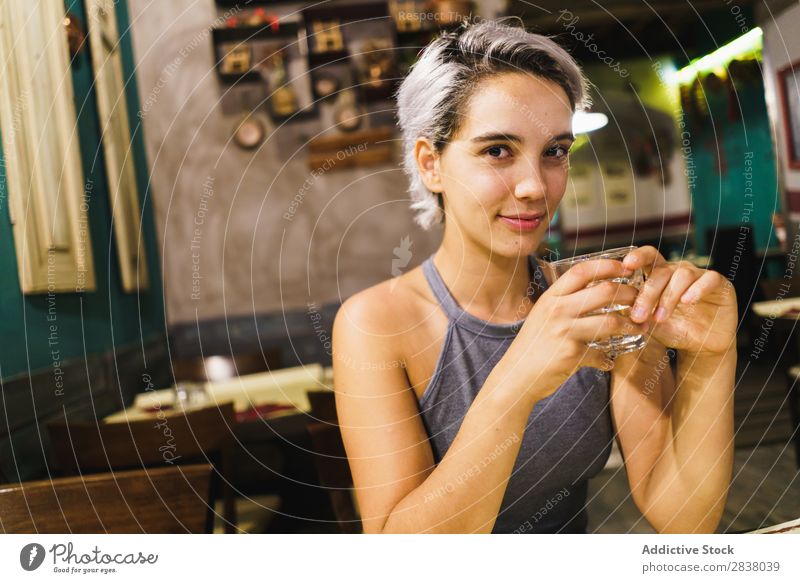 Young woman with drink in bar Woman Bar Posture Feasts & Celebrations Easygoing Drinking Relaxation Interior design Pub Beauty Photography Beverage Glass