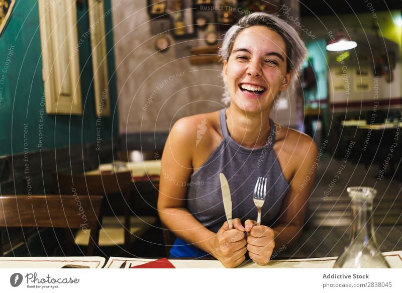 Furious girl posing with silverware Woman Restaurant Appetite having fun Expression facial Emotions humorous hysterical Anger Café Table Adults Stress pretend