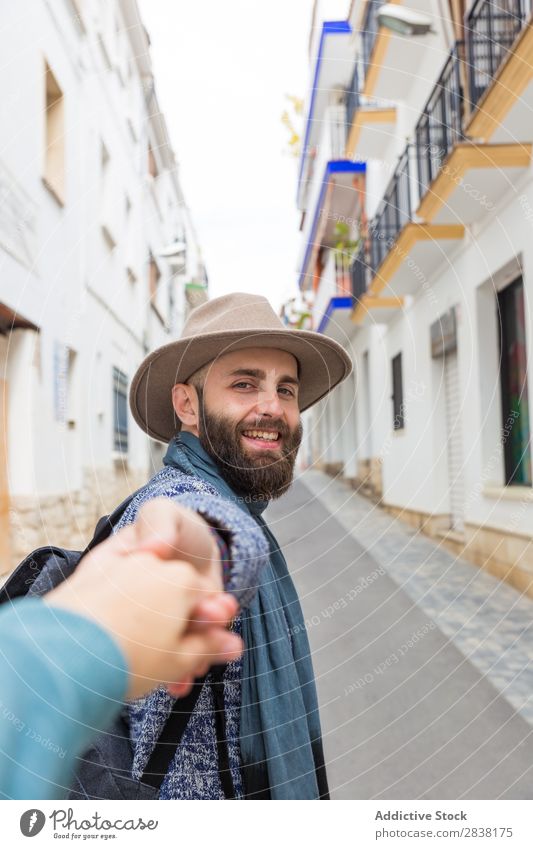 Man holding photographer's hand Tourist follow me Gesture Looking into the camera bearded handsome Smiling Hand gesturing Vacation & Travel Tourism Hat