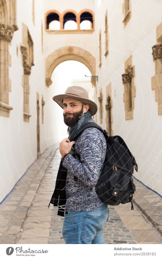 Tourist looking back on alley Backpack Street Looking back Headphones Hat bearded handsome Trip Vacation & Travel Alley City Youth (Young adults) Town Lifestyle