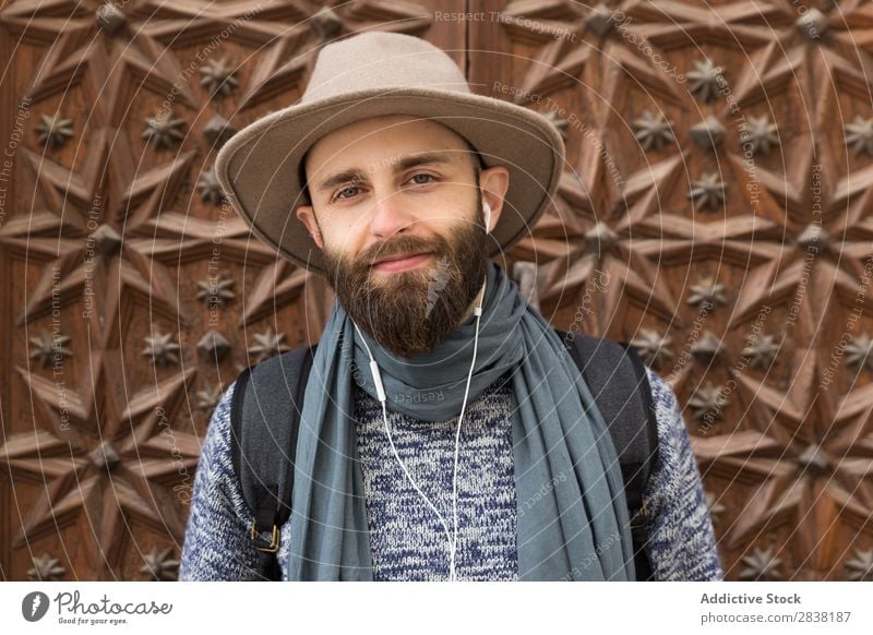 Cheerful bearded man listening to music Man Headphones Style Looking into the camera Contentment Portrait photograph Stand Music Youth (Young adults) Lifestyle