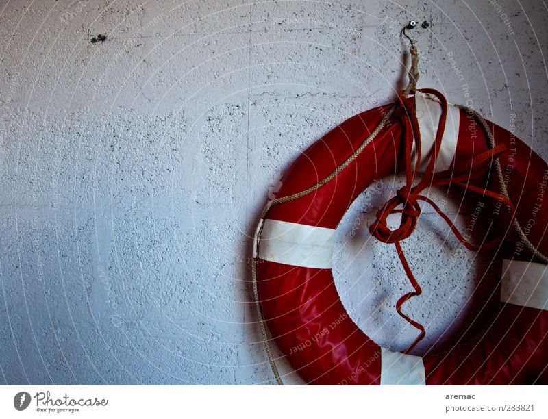 Rescue approaches Wall (barrier) Wall (building) Facade Old Retro Round Red White Safety Protection Dangerous Life belt Garage Colour photo Subdued colour
