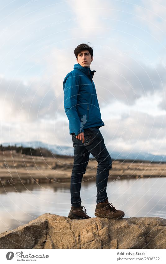 Young man posing against lake Man Posture Lake Portrait photograph Cold Style Adults Landscape Looking Inspiration Earnest Stand fashionable Model Exterior shot