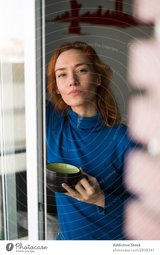 Woman with mug at the window Cup Mug Window Drinking Beverage Hot Looking into the camera pretty Considerate Stand Beautiful Red-haired Youth (Young adults)