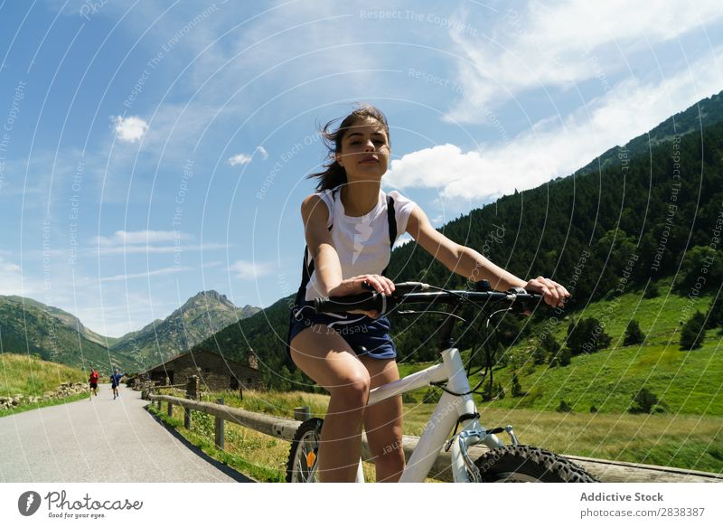 Woman riding bike Athletic Bicycle Cheerful Smiling Looking into the camera Sports Cycle Girl Action Lifestyle Cycling Human being workout Mountain Motorcycling