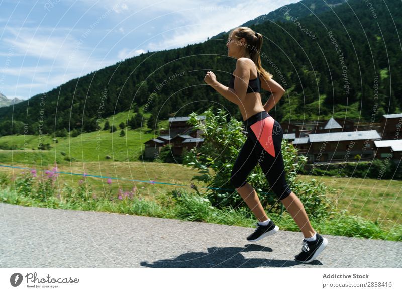 Woman jogging in countryside Street Jogging Rural Athletic Youth (Young adults) Fitness Practice Athlete Sports Landscape workout Leisure and hobbies Action