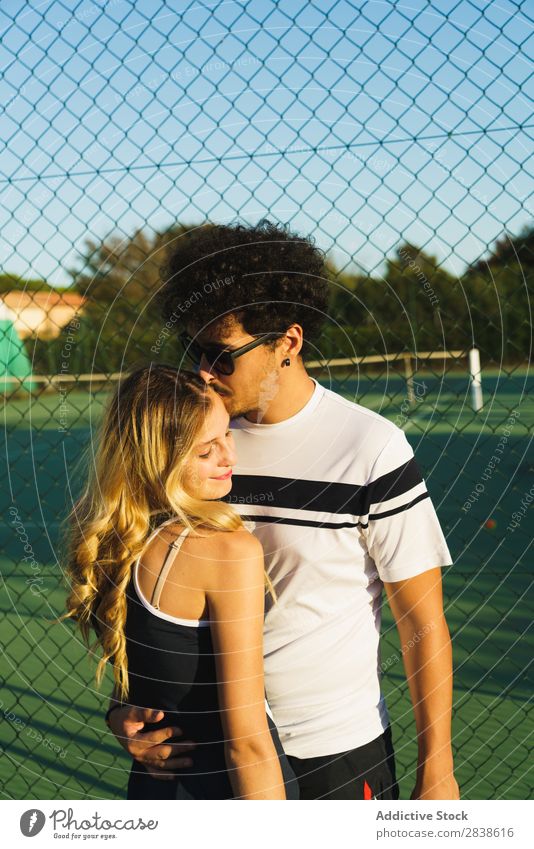 Couple posing on tennis court Posture Athletic Embrace Tennis Leisure and hobbies Sportswear Happiness Relationship Team Joy Together Partner Fitness Action