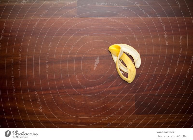 Making a Mistake or Slip-up Fruit Yellow banana skin Story Surface wood sinky peel accident risk potential danger Banana misfortune bad luck unlucky Avoidance