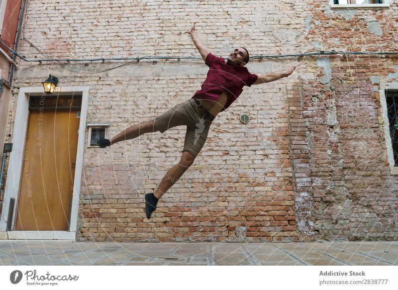 Man jumping on the street Street Town Breakdance Entertainment Athlete Endurance Style Culture Youth (Young adults) Muscular Performance Sports Action Movement