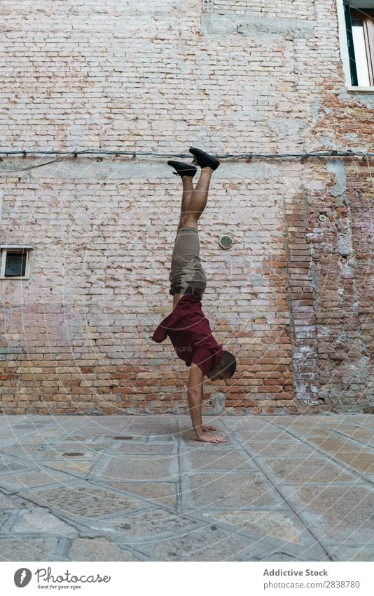 Man performing handstand at old street Handstand Street Town Stand Breakdance Entertainment Athlete Endurance Style Culture Youth (Young adults) Muscular
