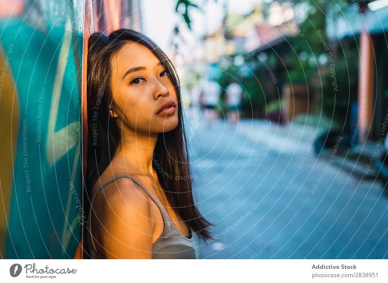 Thoughtful Asian woman leaning on blue door Woman pretty asian Youth (Young adults) Considerate Pensive Cloth Lean Street Town Beautiful Portrait photograph