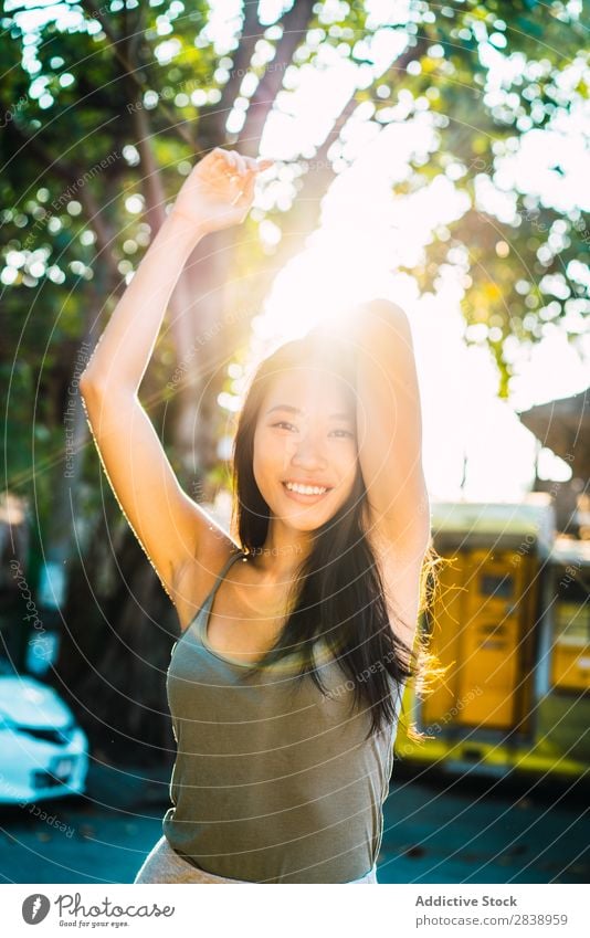 Cheerful Asian woman holding brunette hair Woman pretty asian Youth (Young adults) Smiling Happy holding hair Joy Park Town Brunette Beautiful