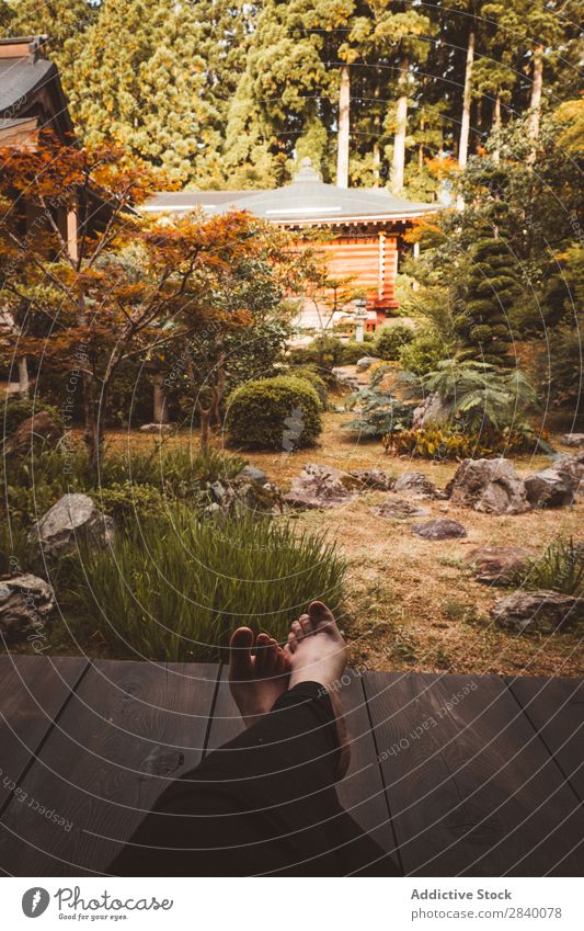 Person relaxing in Asian garden Human being Relaxation Garden asian Tradition Park Nature Legs Barefoot Rest Beautiful Leisure and hobbies Joy Green Autumn