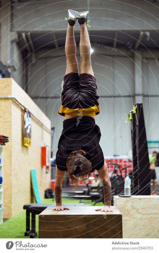 Man standing upside down in gym Gymnasium workout Athletic Fitness Practice Lifestyle on hands Stand Sports Healthy Sportswear Action Human being Beautiful Body