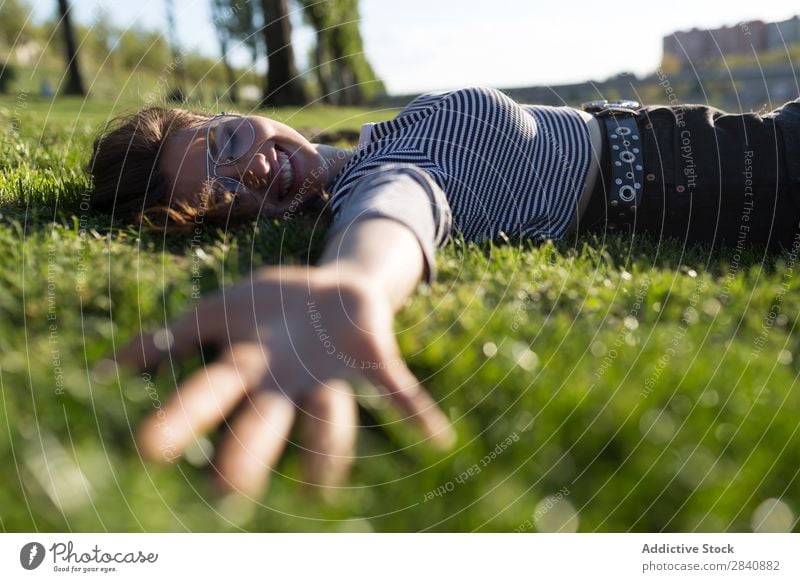 Laughing woman lying on grass Woman follow me Park Nature Summer Dream Vacation & Travel romantic Adventure Smiling Happiness Style Youth (Young adults) Grass
