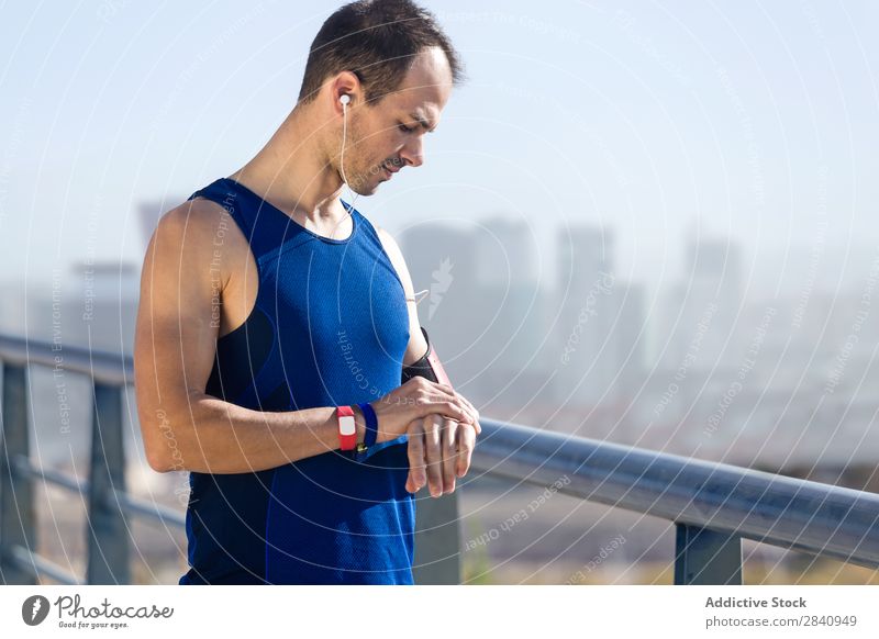 Runner man looking at his pulse with smartwatch. Observe Running Sports Time rate Screen Man Fitness cardio workout Healthy sprint Jogging sprinting Marathon