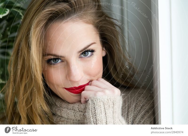 Beautiful young woman looking at camera at home. Blonde Eyes Red Lips Woman Youth (Young adults) Adults Sweater indoor Home Girl Smiling only 1