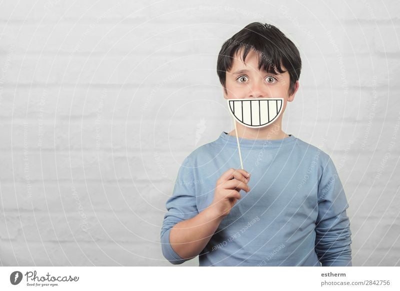 funny and smiling child with a cardboard smile Joy Playing Human being Masculine Child Infancy Teeth 1 8 - 13 years To hold on Fitness Smiling Laughter