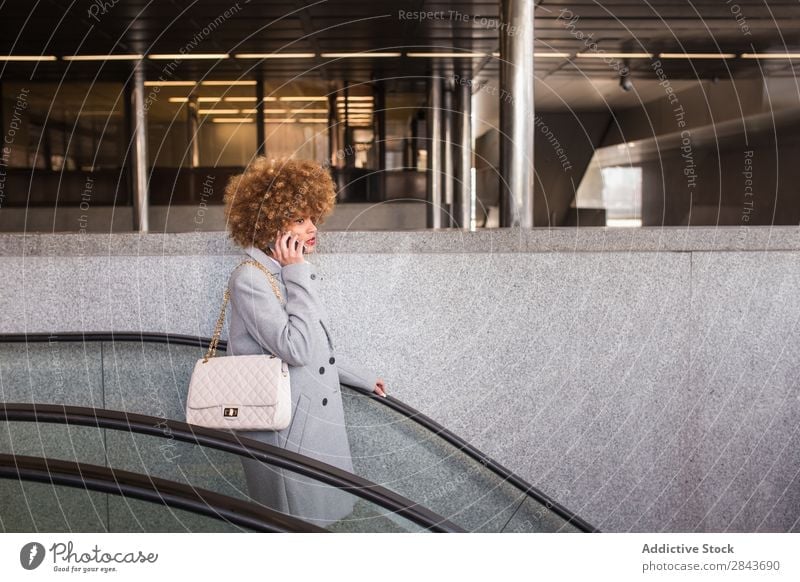 Stylish woman with phone on escalator Woman Style Adults pretty PDA To talk moving stairs Escalator downstairs Hair and hairstyles Blonde Ethnic Beautiful