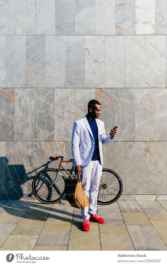 Stylish black man with phone outside Man Style Street PDA Elegant Posture Black Hip & trendy Business Suit classy Model Technology Success Observe Communication