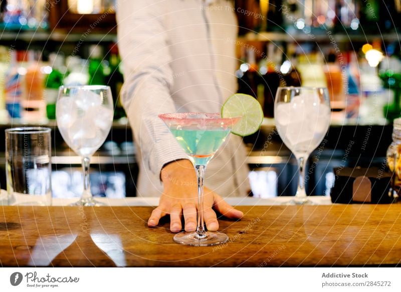 Hand of bartender with cocktail Man Bar Counter Glass Preparation Cocktail Party Alcoholic drinks Drinking Restaurant barman Night life Stir Pub Beverage