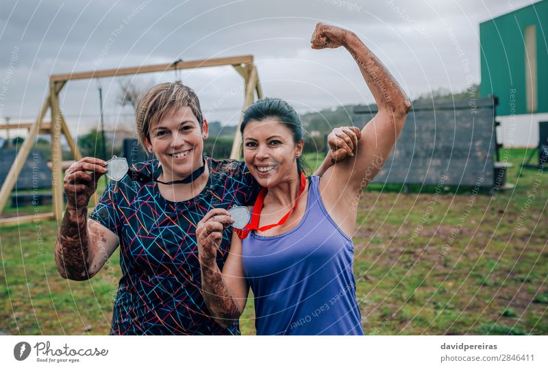 Two female athletes showing medals after race Happy Feasts & Celebrations Sports Award ceremony Success Human being Woman Adults Arm Hand Smiling Authentic
