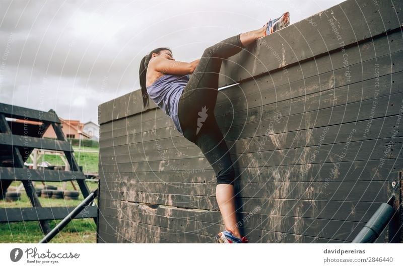 Female participant in obstacle course climbing wall Lifestyle Sports Climbing Mountaineering Human being Woman Adults Sneakers Authentic Strong Loneliness