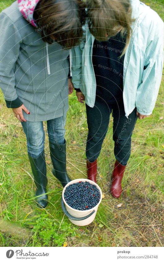 marvel at booty Food Fruit Adventure Human being Feminine Young woman Youth (Young adults) Friendship 2 Nature Meadow Observe Stand Blueberry Rubber boots