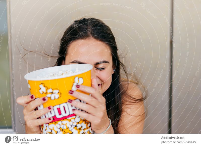 Lovely girl posing with popcorn Woman youngster Popcorn Laughter Joy Town Cheerful Bucket Playful Hipster Style Clothing Portrait photograph covering face