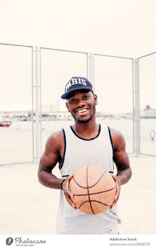 Black man posing smiling Man Basketball outstretching street ball Self-confident Sports ground Town Masculine Street sportsman Style Posture African-American