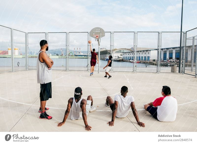 Men watching others playing basketball Man street ball Playing Sports ground Observe Basketball Athletic Relaxation Fitness Leisure and hobbies Town Jump Action