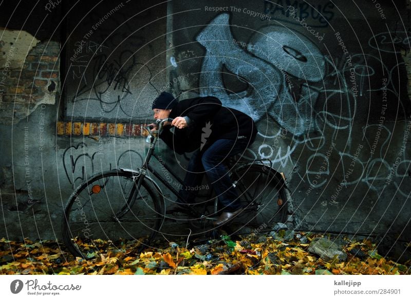 headwind Bicycle Human being Masculine Man Adults 1 30 - 45 years Autumn Vehicle Driving Steering Haste Speed Wall (barrier) Graffiti Leaf Duck down