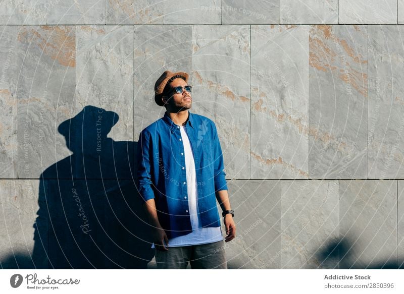 Man with hat posing in wall City Stand Hat Human being Town Adults Modern Lifestyle Loneliness Portrait photograph fashionable Fashion Elegant Wall (building)