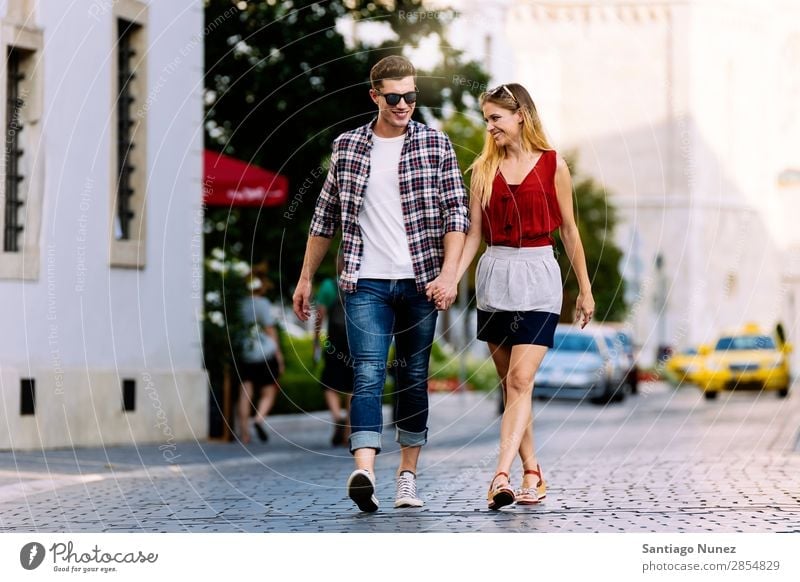 Romantic Young Couple Walking in the City. Relationship Love Youth (Young adults) Happy Laughter Smiling Human being Summer Street Europe Together Caucasian