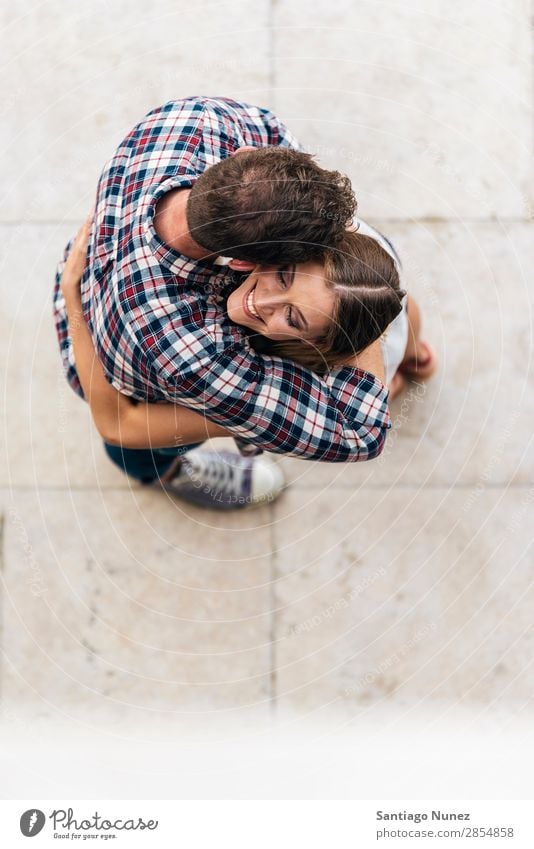 Young loving couple hugging in the street. From top view. Couple Love Woman Relationship Youth (Young adults) Beautiful Embrace Romance Happiness Kissing