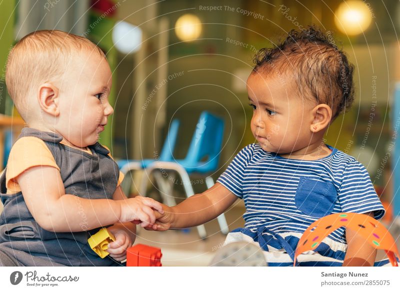 Babys playing together. Playing Child Kindergarten doing 2 Joy Boy (child) childcare Happy mulatta multiethnic Caucasian Home Infancy Lifestyle Human being Girl