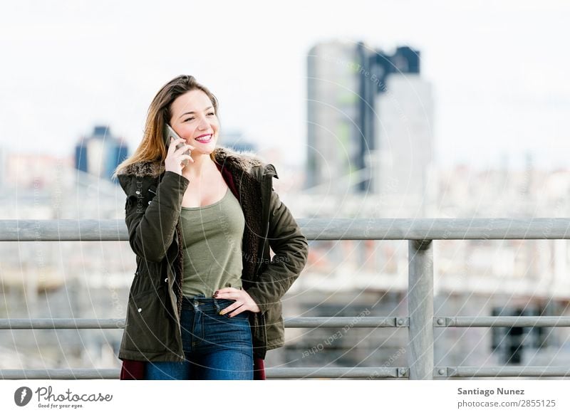 Beautiful woman at phone in the city. Telephone Woman City To talk Street Easygoing Mobile Youth (Young adults) Smart Background picture Happy speaking
