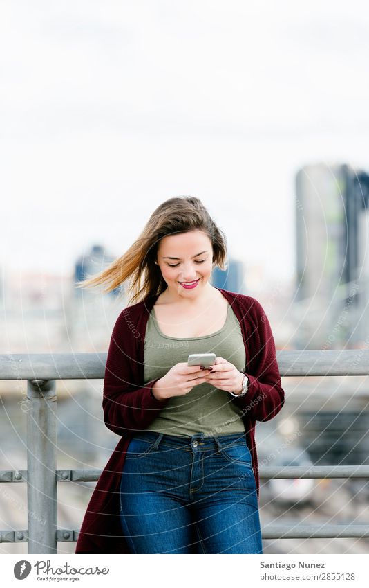 Happy girl texting on a smartphone. Telephone Mobile Woman Girl Human being PDA SMS Background picture Beautiful Communication using City Lifestyle Smart