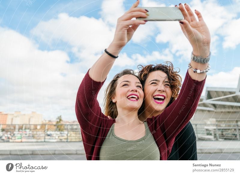 Two beautiful women taking selfiein the street. Selfie Laughter Happy Friendship girlfriends Youth (Young adults) Portrait photograph Summer Lifestyle Woman Joy