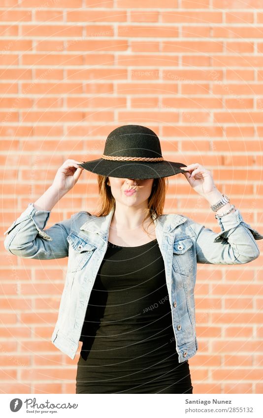 Blonde hipster posing with straw hat against orange brick background. Fashion Wall (building) Girl Hip & trendy Woman Youth (Young adults) Hipster Easygoing