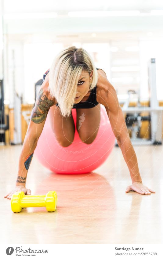 Beautiful woman doing exercises at gym with fitness ball. Woman Gymnasium workout Push Looking pushups Fitness Practice Youth (Young adults) Body Ball Adults