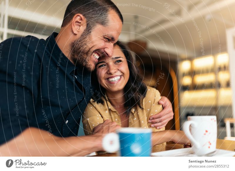 Smiling couple of lovers having fun. Love Embrace Couple Coffee Youth (Young adults) Beautiful Adults Woman Romance Man Sit To talk Easygoing romantic