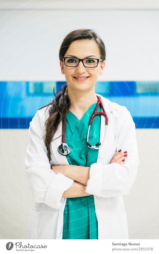 Smiling beautiful doctor at hospital. Standing. Arm Attractive Background picture Beautiful Considerate Caucasian Cheerful clinician Doctor Equipment Woman