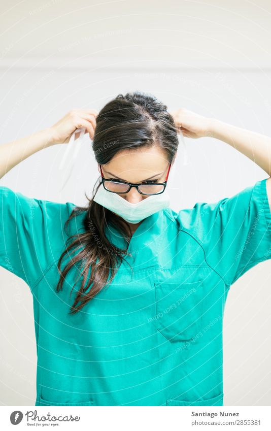 Nurse working putting her medical mask Blue Considerate clinic Cover Doctor Equipment Woman Green Healthy Hospital Human being indoor Profession Mask Medication