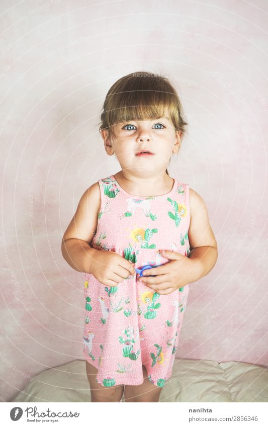 Young little and funny girl in a studio shot Lifestyle Joy Happy Face Child Baby Toddler Woman Adults Infancy Dress Blonde To enjoy Happiness Funny Cute Pink